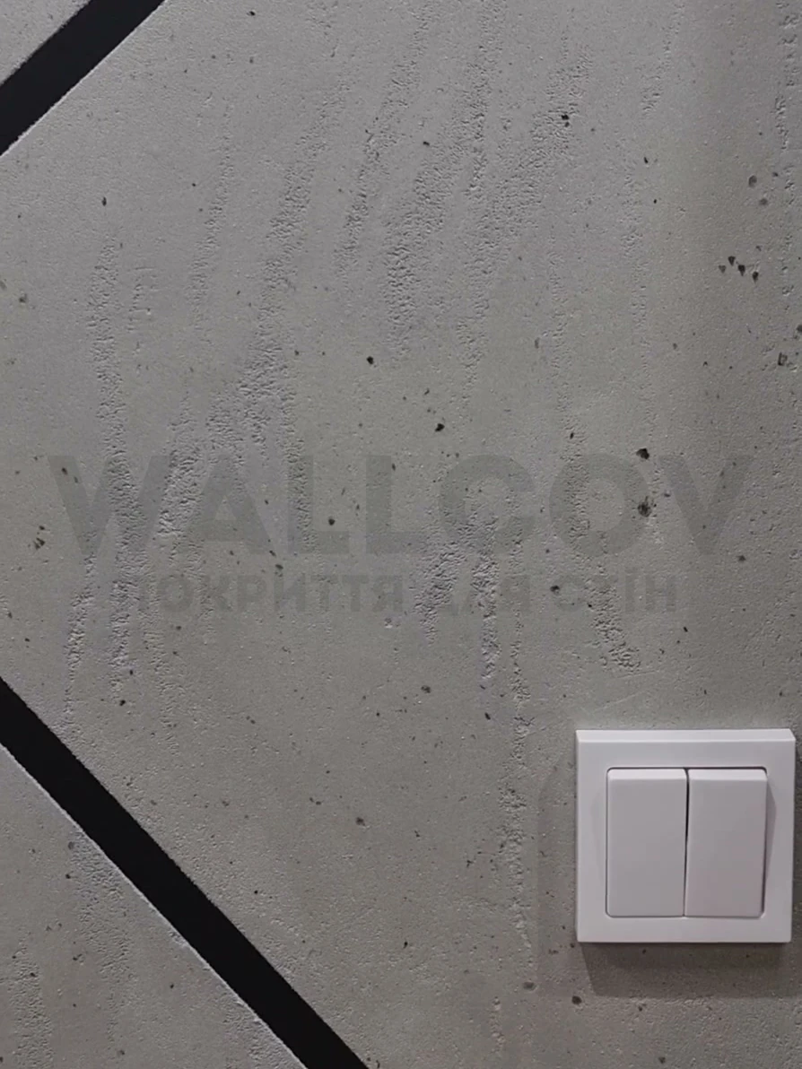 Реальний об'єкт Wallcov: стіна під бетон з чорними діагональними вставками та вимикачем